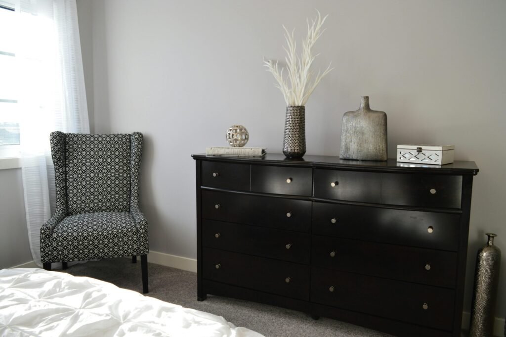 Sleek and stylish bedroom with modern black furniture and elegant decor.